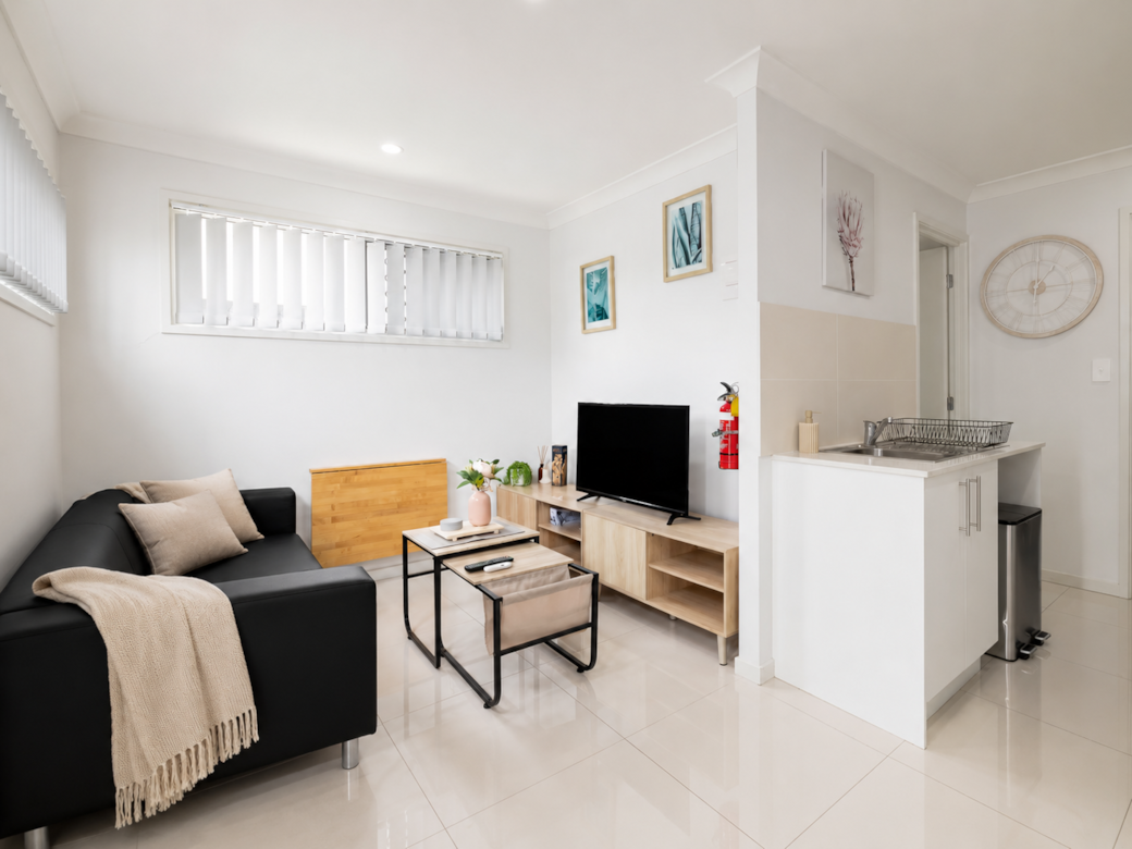 Living Area: Bright living space with comfortable seating and TV 