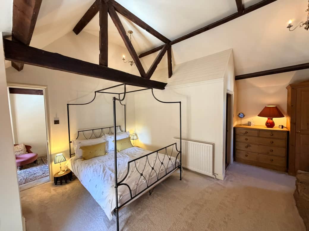 Bedroom 1 with a king size four poster bed and private ensuite bathroom