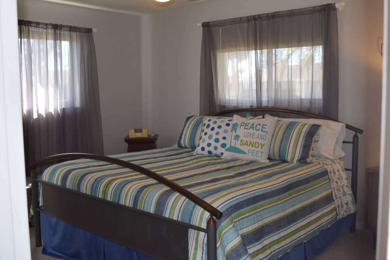 Master bedroom with king bed, closet with dresser and private bath.