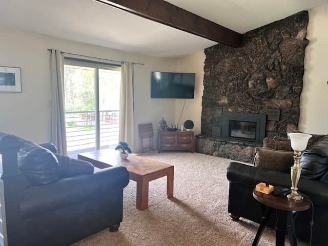 livingroom with gas fireplace and sliding door to the balcony