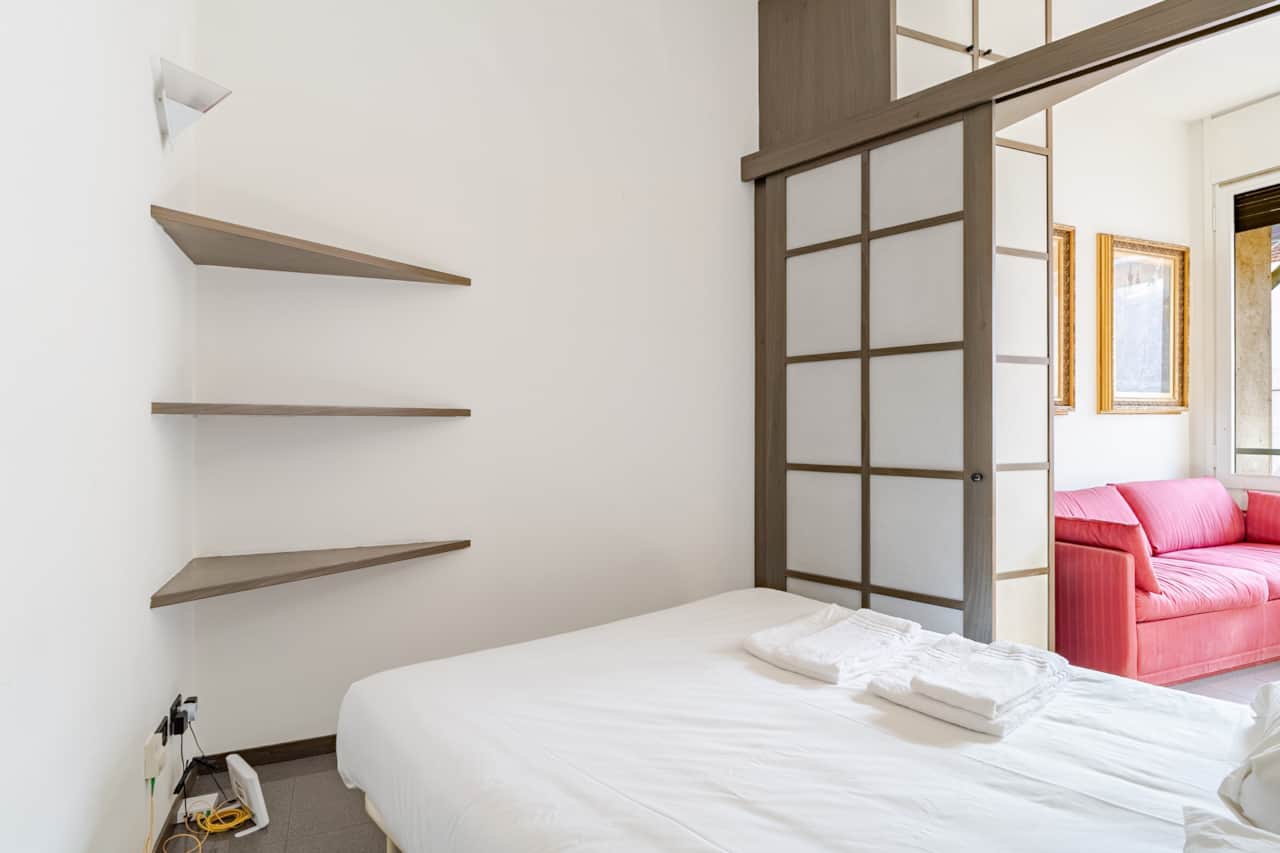 Bedroom with bed and wall ladder rack