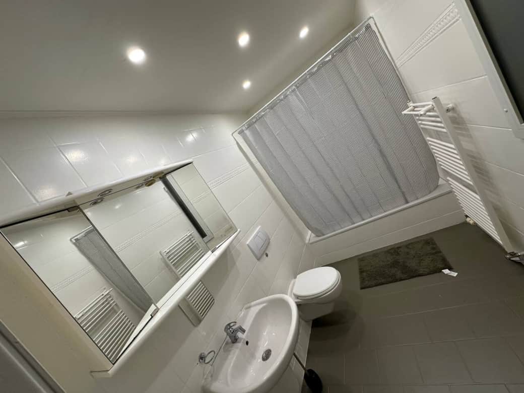 Comfortable Bathroom with Bathtub and Towel Heater Comfortable Bathroom with Bathtub and Towel Heater
