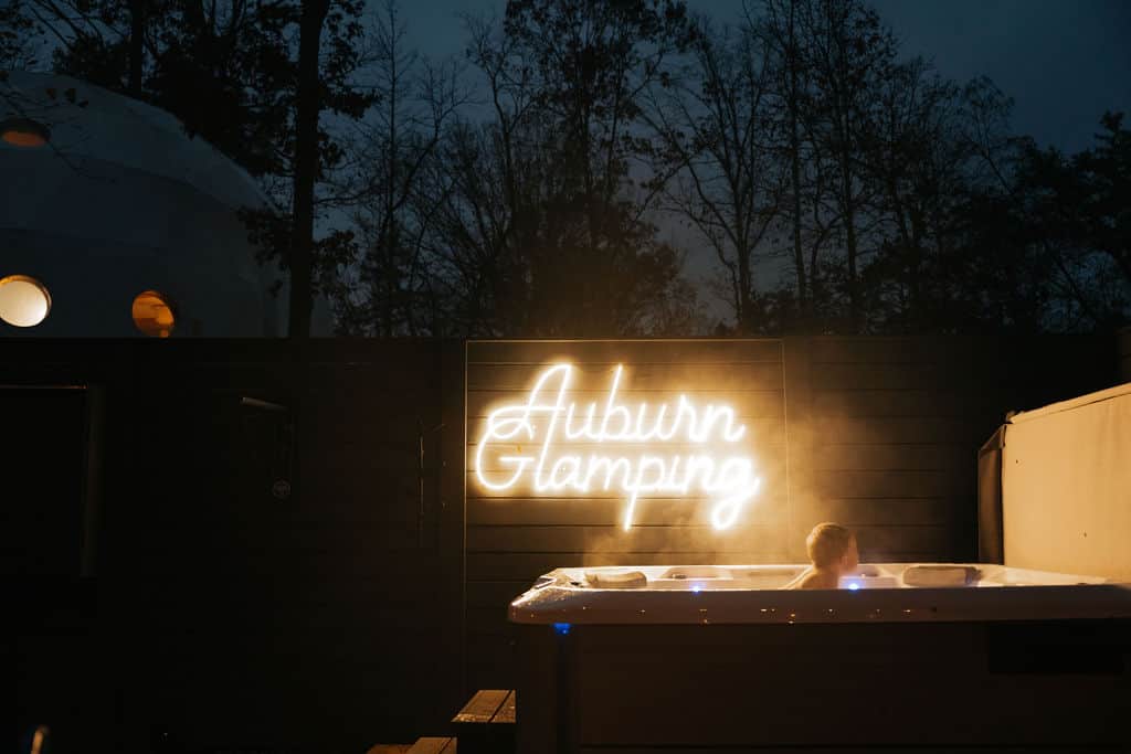 Private hot tub at night during a winter glamping stay in Alabama