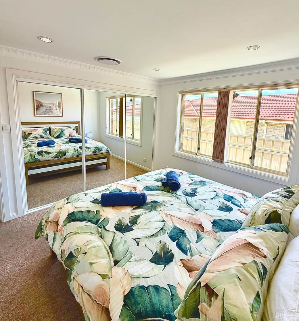 Comfortable king-size bed with fresh linen, four pillows, two shower towels, two face towels, a large wardrobe, bedside lamps, and an air-conditioning system