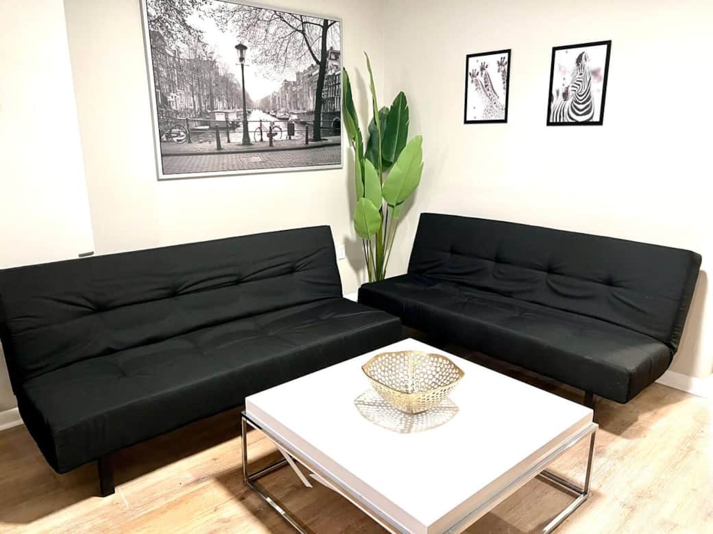 The living room features two comfortable futon sofa beds, perfect for relaxing or accommodating extra guests. Fast WiFi, 55 inch flat-screen TV, equipped with a variety of Roku channels, and an electric fireplace..
