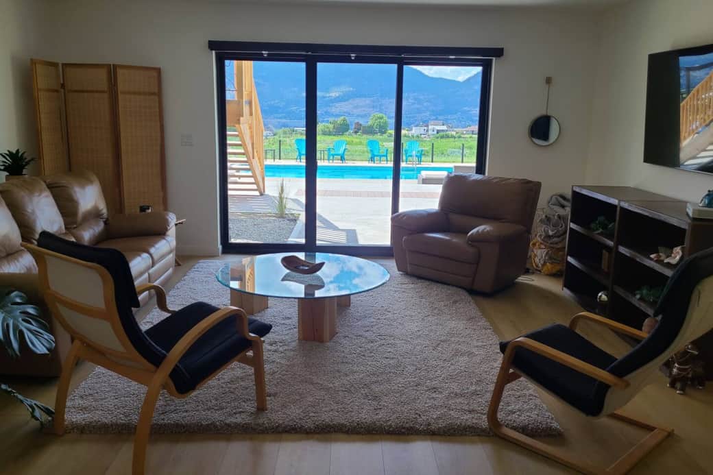A large living room with walk-out access to the pool.