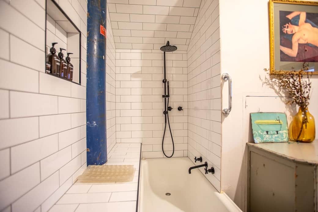 Relax and unwind in a spacious bath with a rain shower—mountain luxury at its best.