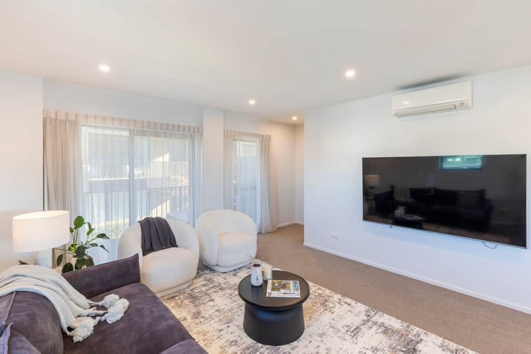 Living area including 78 inch wall mounted television.