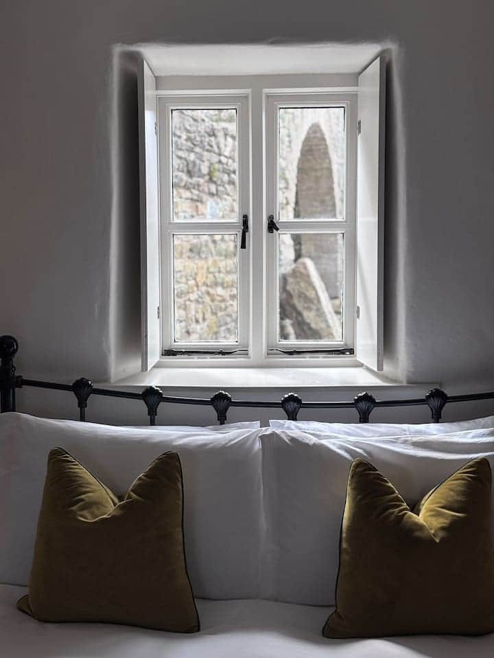 View onto 16th century ruins of Legan Castle and ogham stone dating back to 400 AD