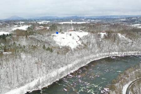 A snowy mountain top overlooking the French Broad River
