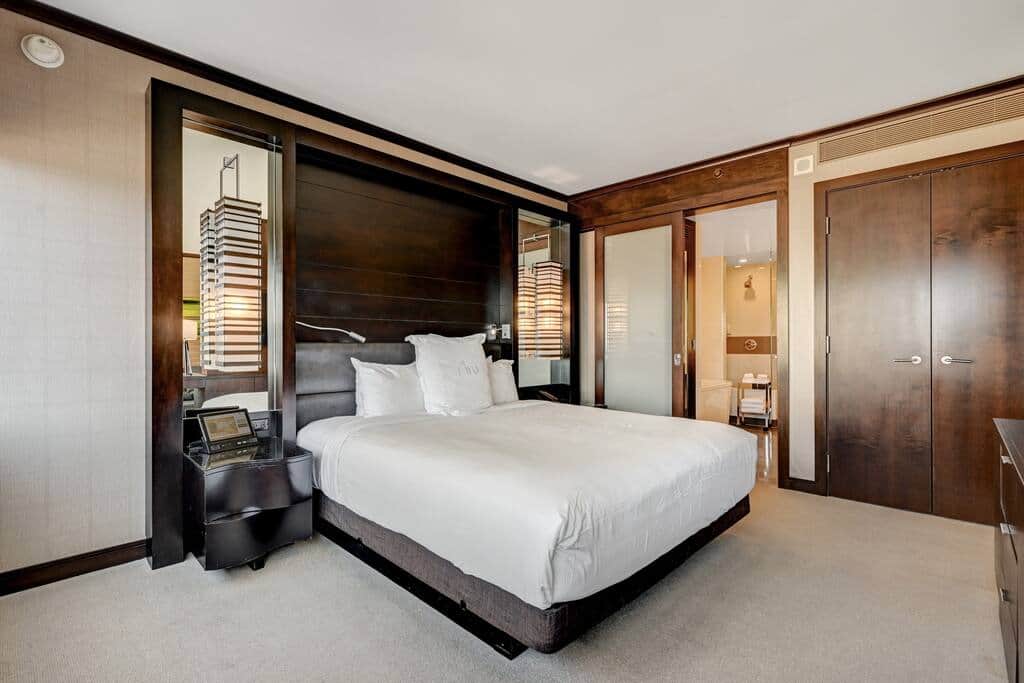 Plush King Bed with Modern Wood Headboard and Soft Lighting Plush King Bed with Modern Wood Headboard and Soft Lighting