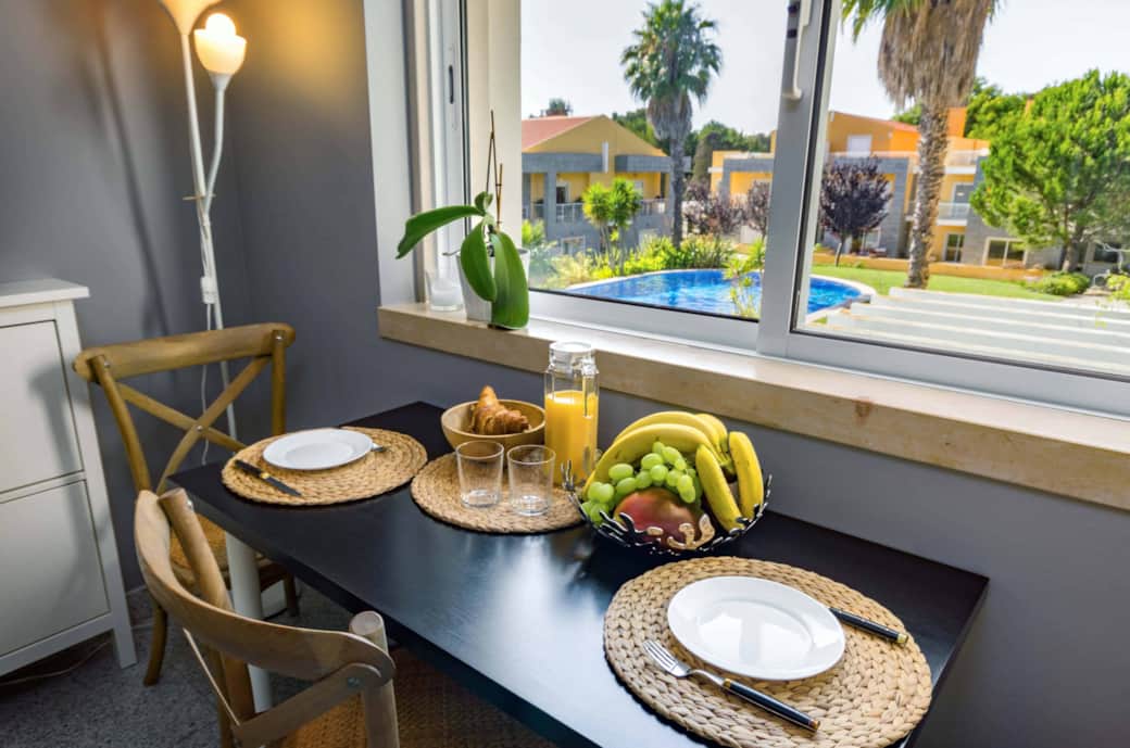 Kitchen eating nook with views over the garden and shared pool