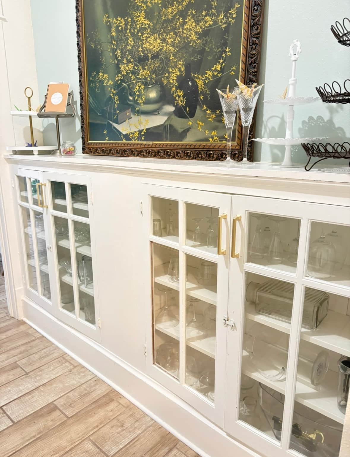 A china cabinet original to the home holds lots of glassware for guest use.