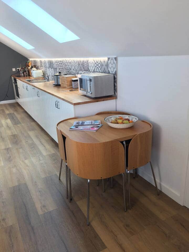 Kitchen area includes a small table and chair set which seats two and is handy for dining or working Kitchen area includes a small table and chair set which seats two and is handy for dining or working