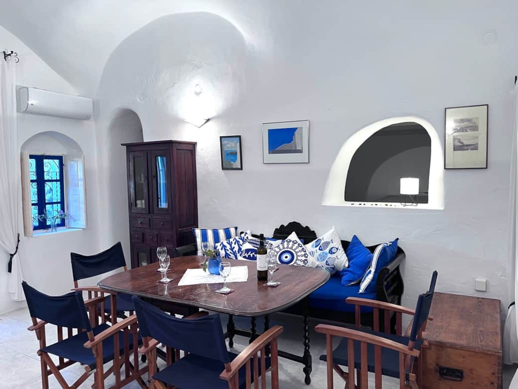 Bright Santorini living room with cozy seating and traditional décor..