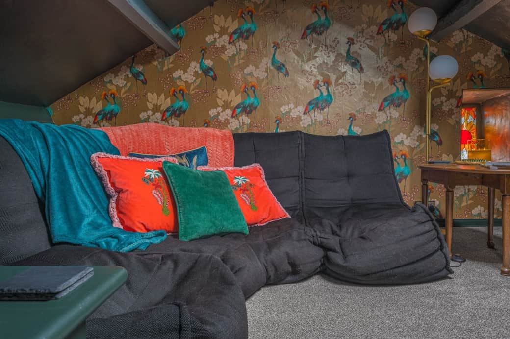 Tucked away in the cinema room, you stretch out on the sofa and settle in. This is your cosy corner for the evening.