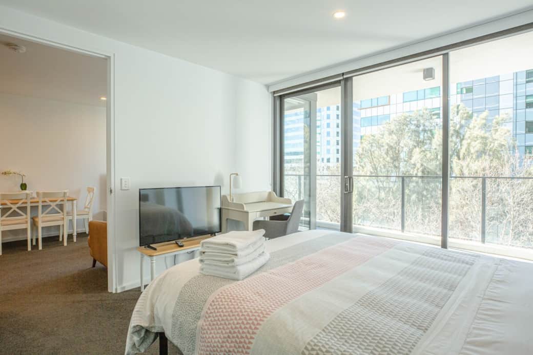 Experience luxury in our master bedroom, complete with a private balcony. The room's design, accentuated by a large bed and a flat-screen TV, offers a haven of tranquility with a touch of indulgence. Study desk and TV in the bedroom provided ，either.