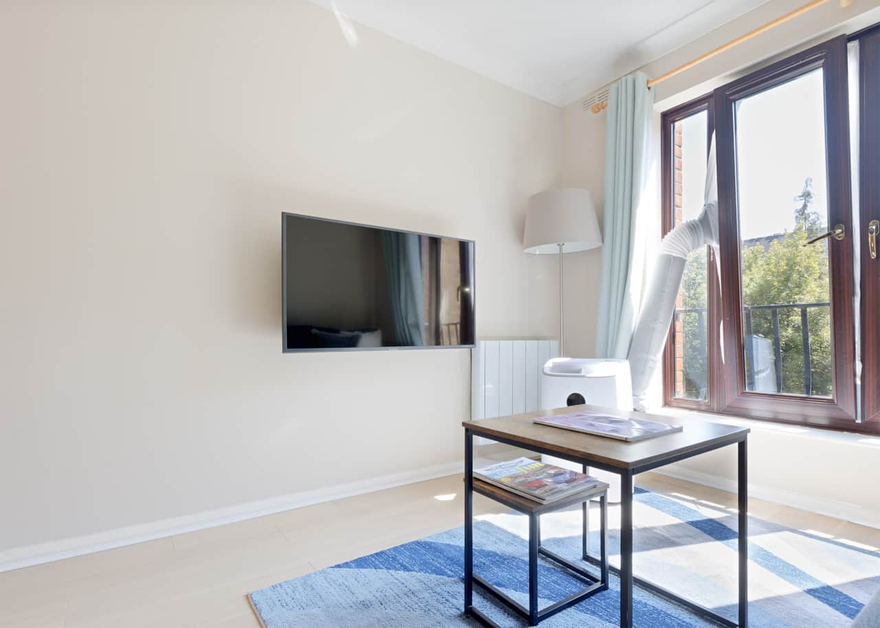 Living room seating with tv floor lamp and balcony access