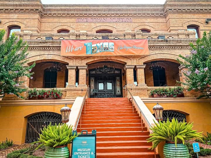 The Bryan Museum exterior with lush gardens and historic arches in Galveston
