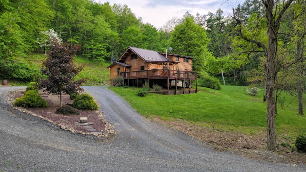 Secluded log home is nestled in the woods, offering seclusion and tranquility. 