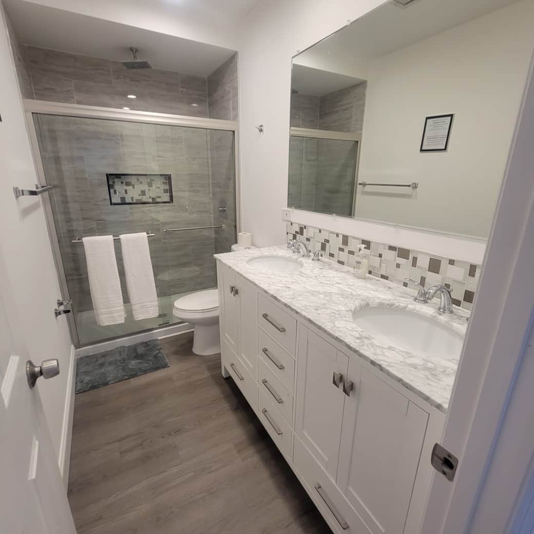 Impeccable modern bathroom with toilet, shower, sink, and essential amenities. Lakeland, FL Impeccable modern bathroom with toilet, shower, sink, and essential amenities. Lakeland, FL