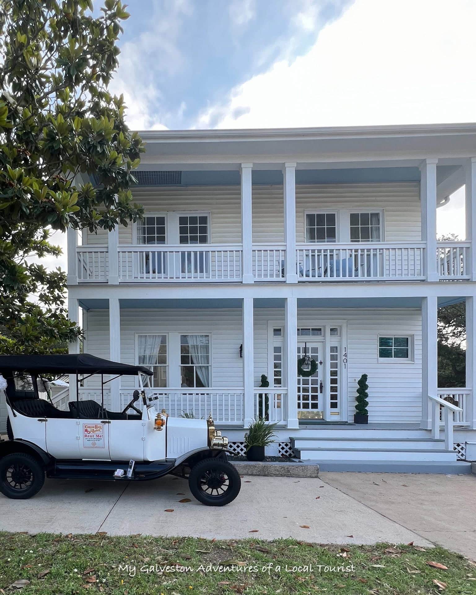 A Carriage Haus vintage-style golf cart parked in front of White Magnolia Galveston
