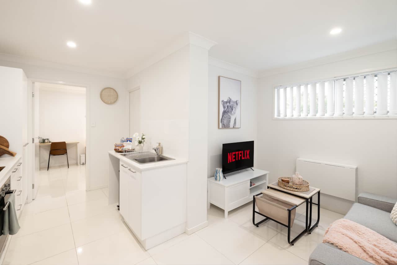 Living Area: Bright living space with comfortable seating and TV 