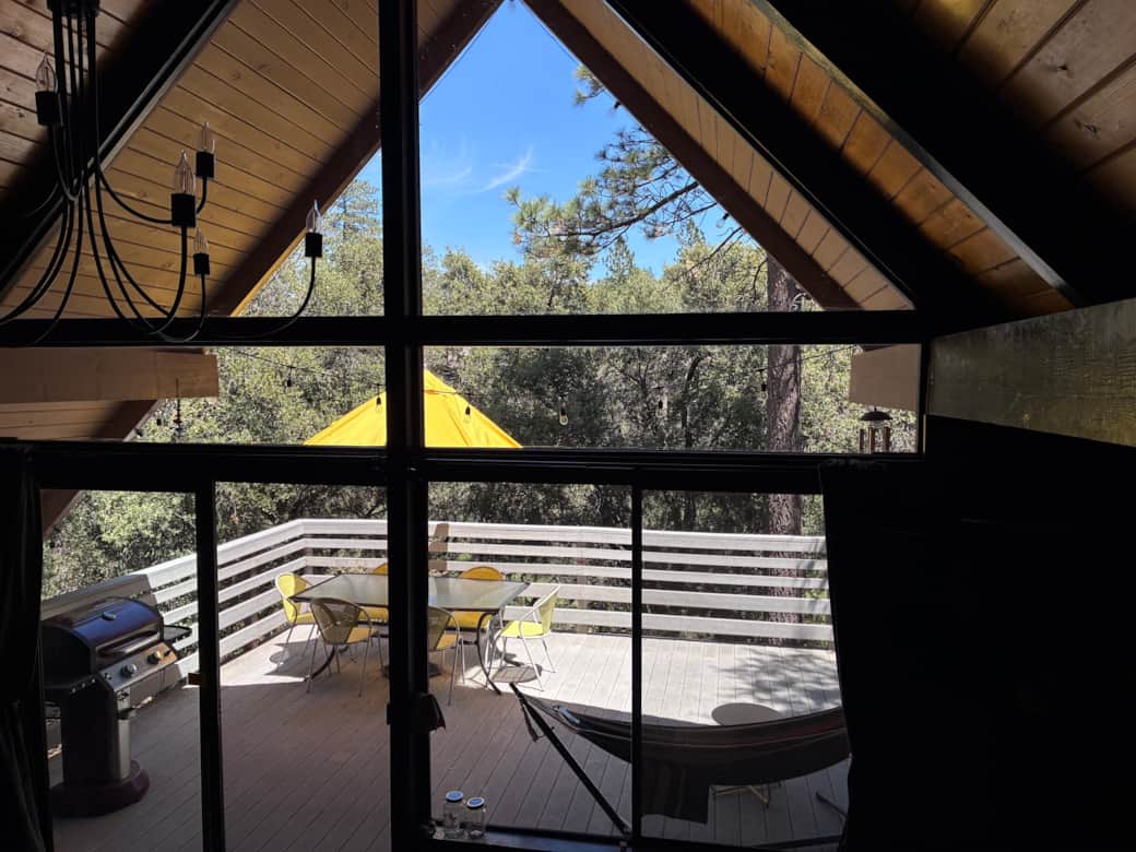 View from the living room onto the East deck overlooking protected forest.