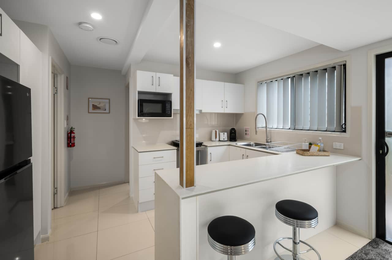 Kitchen: Sleek kitchen with ample storage, modern appliances 