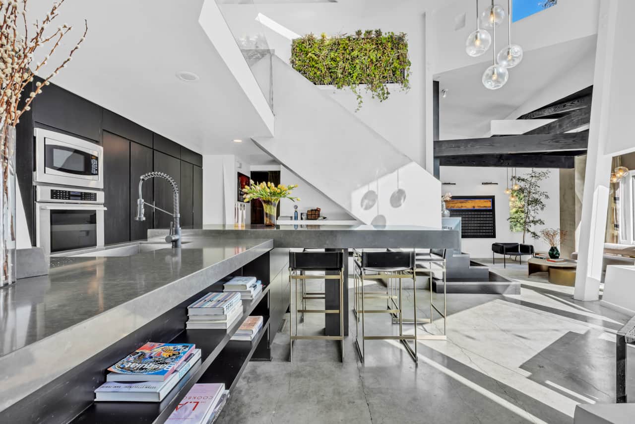Savor the charm of our kitchen, featuring modern appliances and a cozy dining counter.