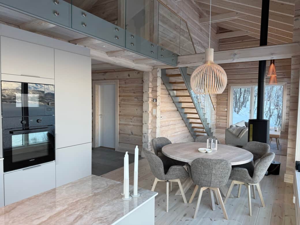 Open kitchen with staircase and mountain panorama – cabin Nordlys Norway
