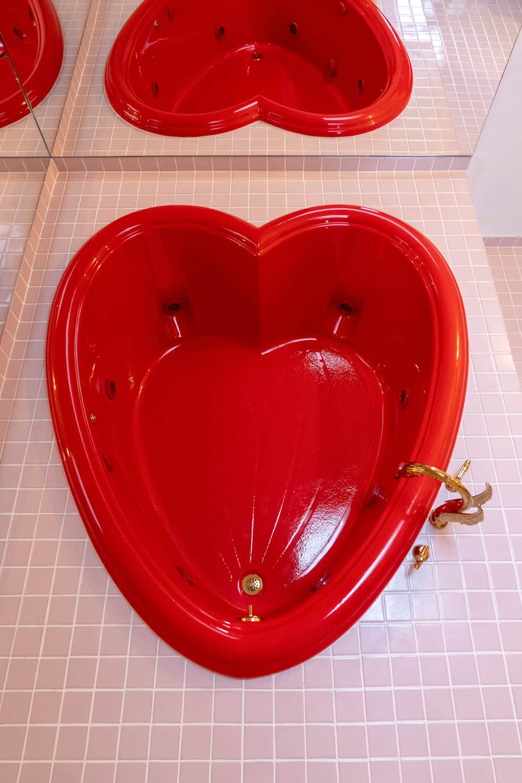 Heart-shaped red jacuzzi tub, an iconic Sweetheart Hideaway detail Heart-shaped red jacuzzi tub, an iconic Sweetheart Hideaway detail