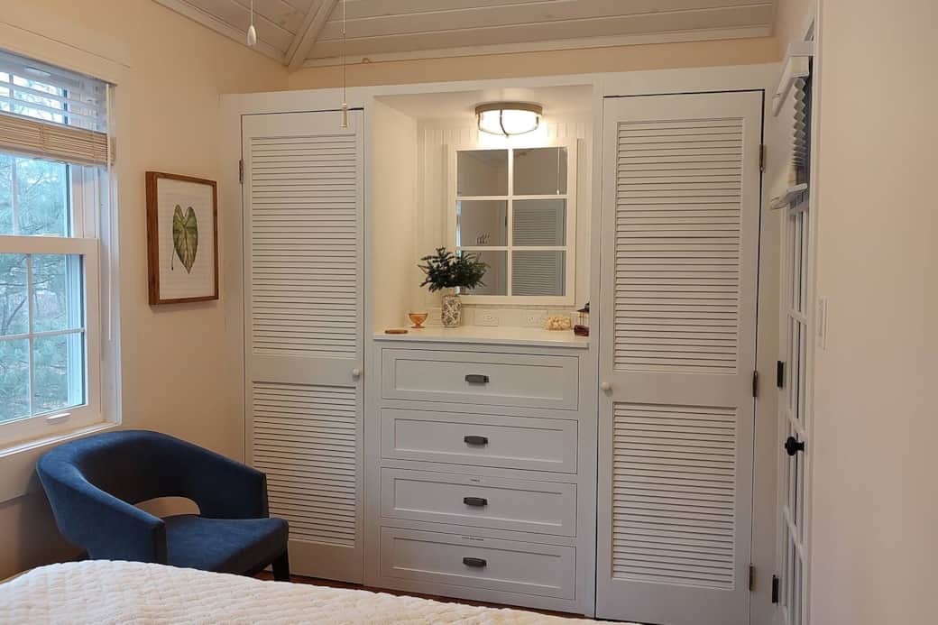 South queen bedroom. This bedroom looks out over a wooded lot. There's a Coleman lantern on the dresser...nice to have on a late night stroll.