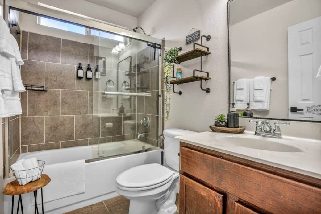 Full bathroom with a full-sized tub, shower head with great water pressure, hand soap, shampoo, conditioner, body wash, extra toilet paper, hand soap, towels and wash cloths, makeup remover towels, cleaning supplies, and ample storage space. Full bathroom with a full-sized tub, shower head with great water pressure, hand soap, shampoo, conditioner, body wash, extra toilet paper, hand soap, towels and wash cloths, makeup remover towels, cleaning supplies, and ample storage space.