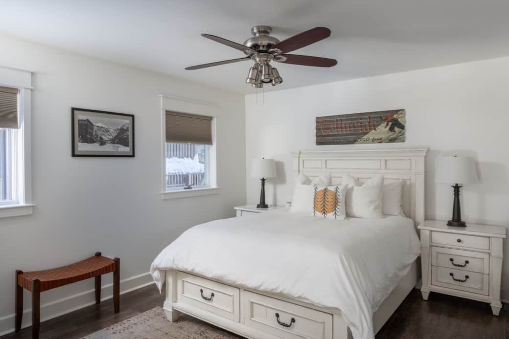 The primary bedroom features a queen bed, ceiling fan and ensuite bathroom