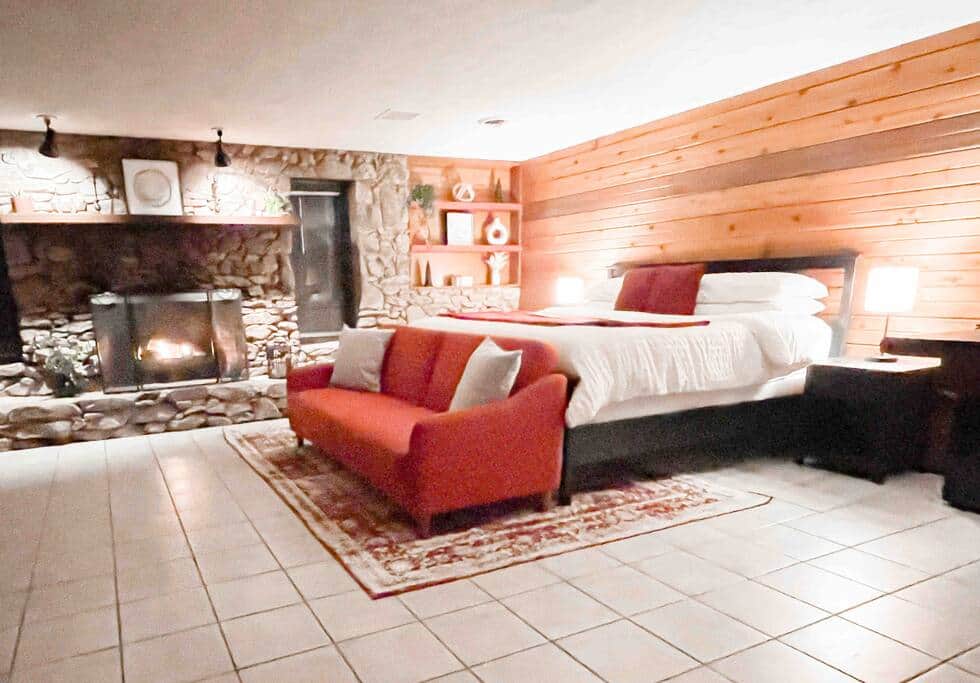 The basement provides a large, cozy king bed with a gas fireplace.