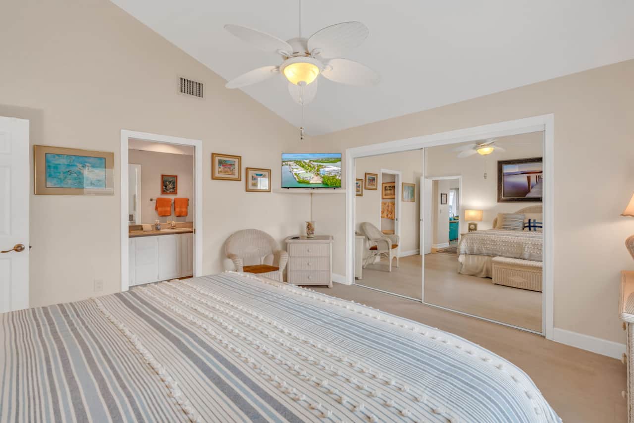 Master bedroom king with large mirror and ensuite