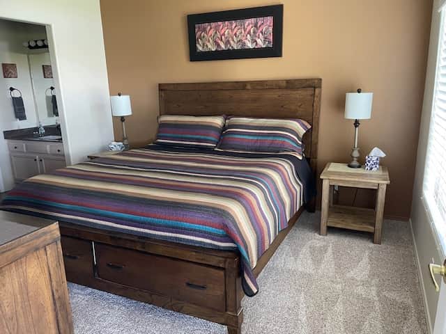 Primary king, opens to vanity nook, bathroom and walk-in closet