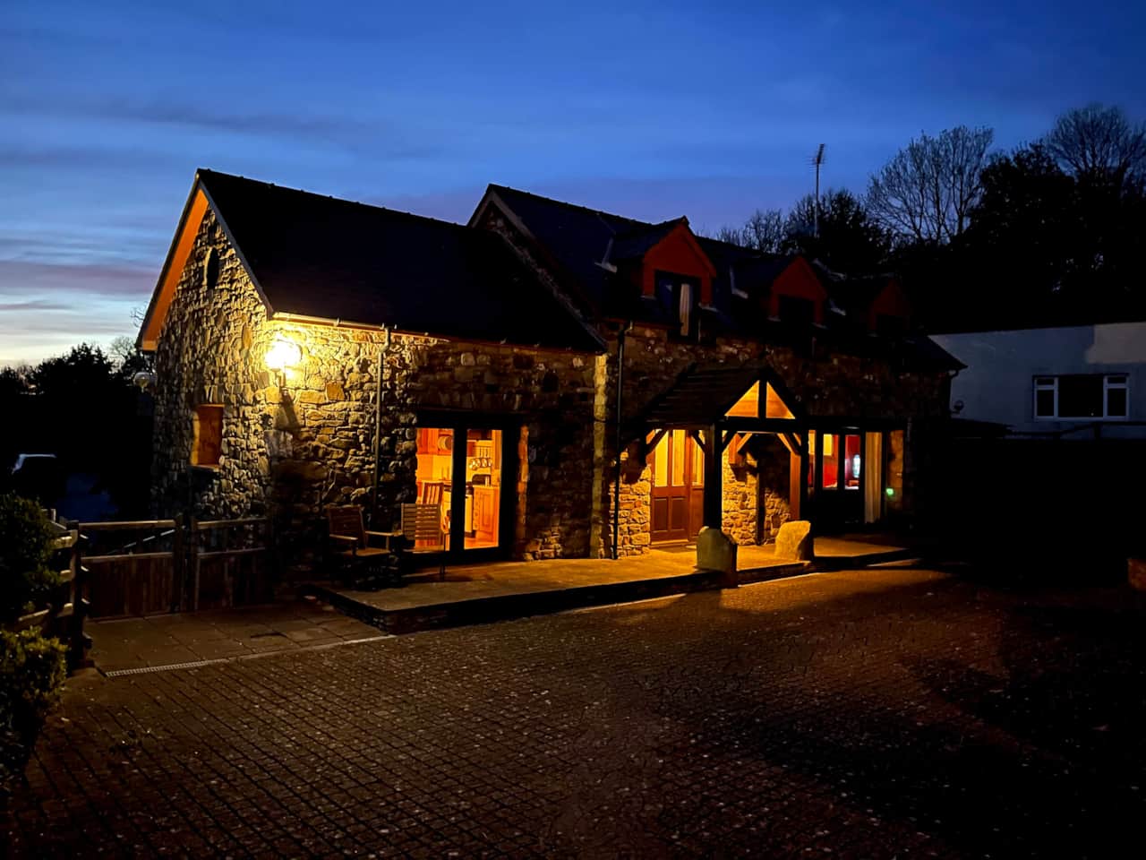 Cottage exterior beautifully lit up at night