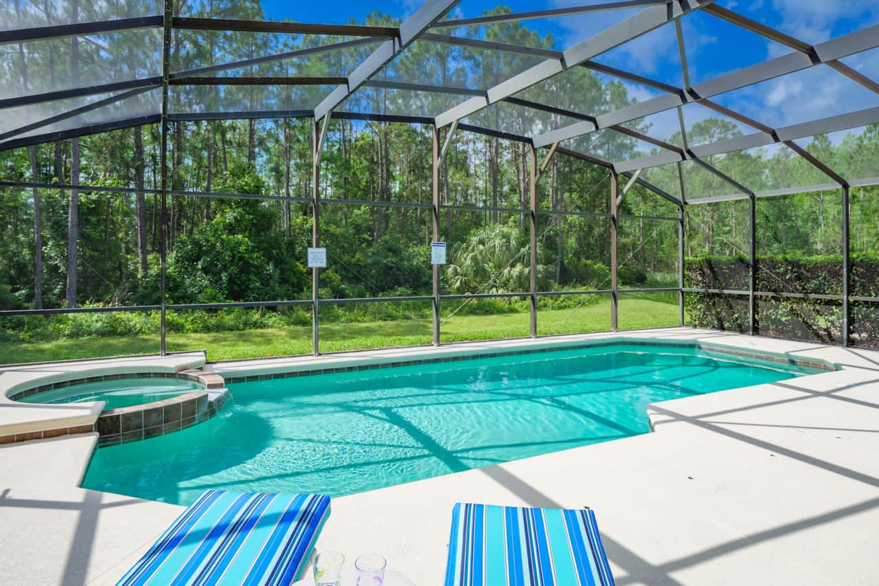 There is a raised Jacuzzi spa attached to the pool area
