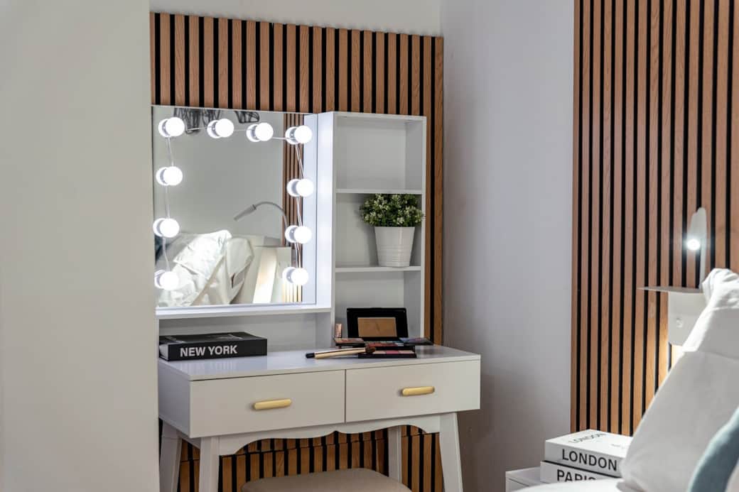 A stylish vanity corner with mirror and soft lighting — perfect for getting ready in comfort and style.

