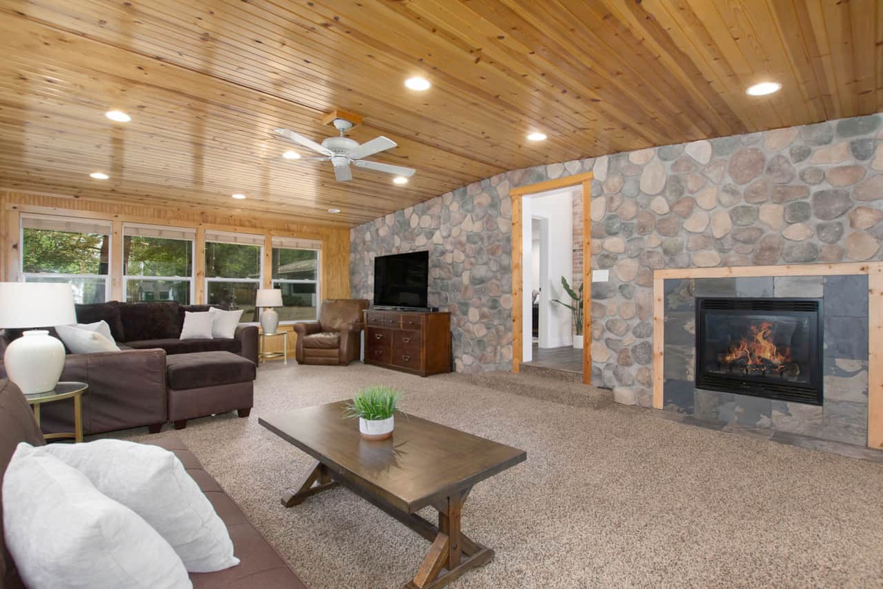 Large four seasons room offering a fire place, Smart TV and plenty of room to relax and hangout.