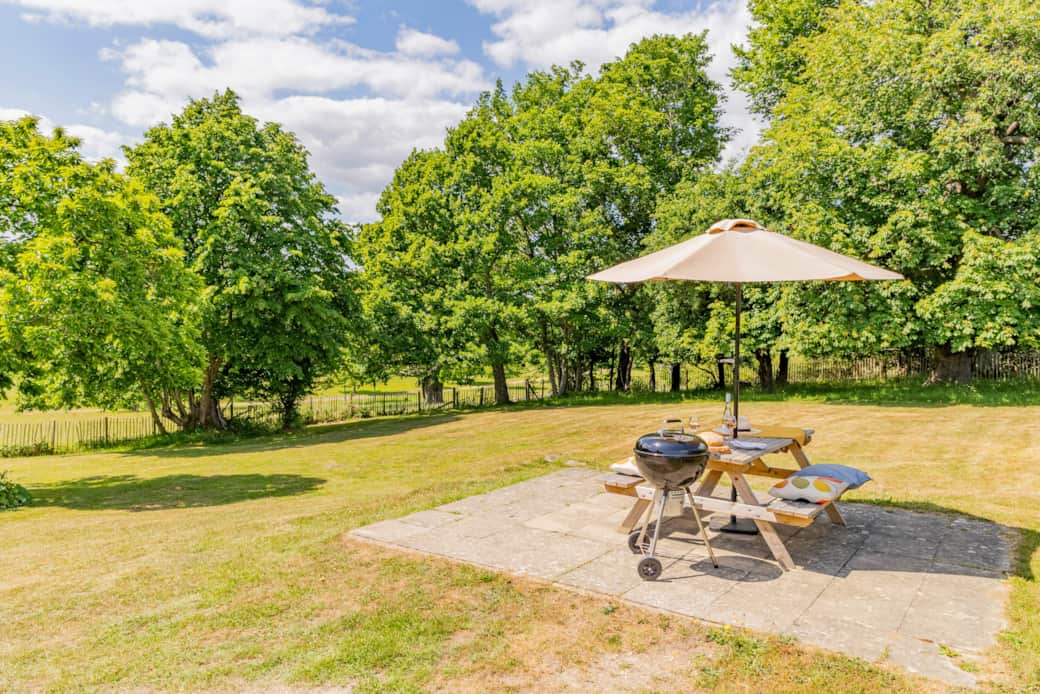 Private garden with picnic bench and parasol