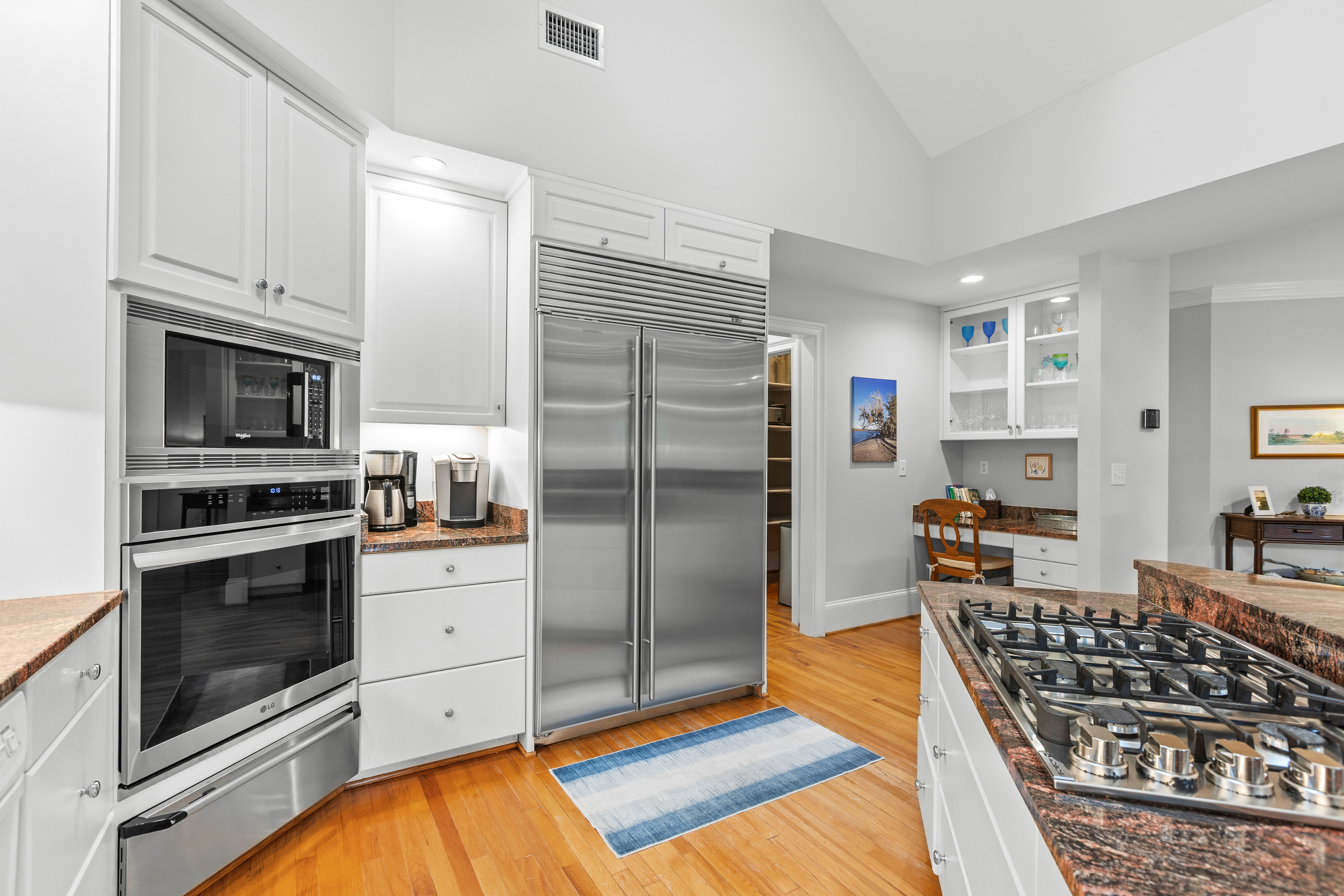 Built-in refrigerator with a wall oven and microwave alongside
