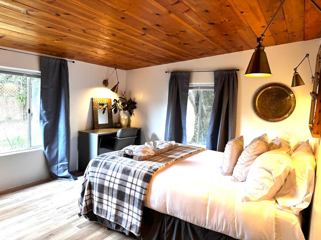 Master bedroom features a comfy bed and ensuite bathroom.