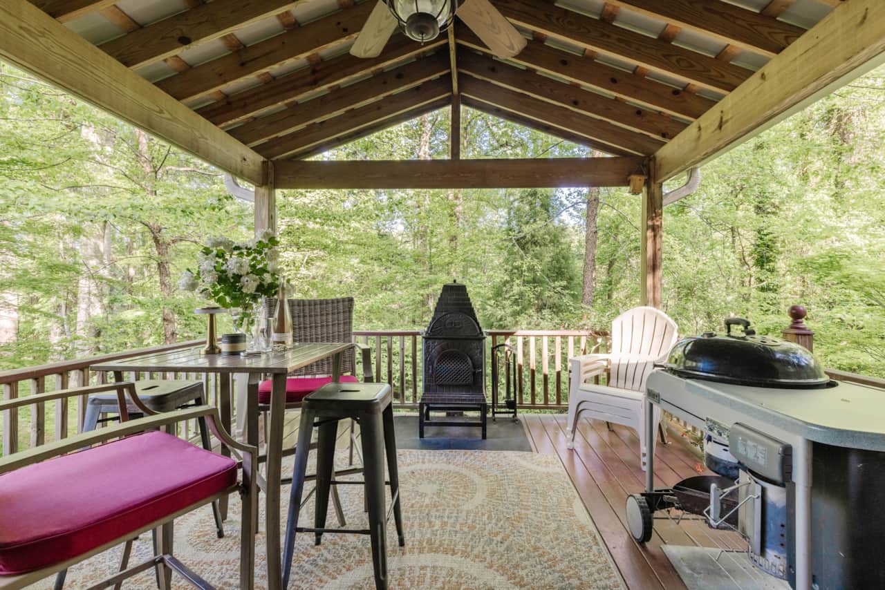 Back Porch overlooking the woods & dog run, grill, woodstove/Pizza Oven & more seating