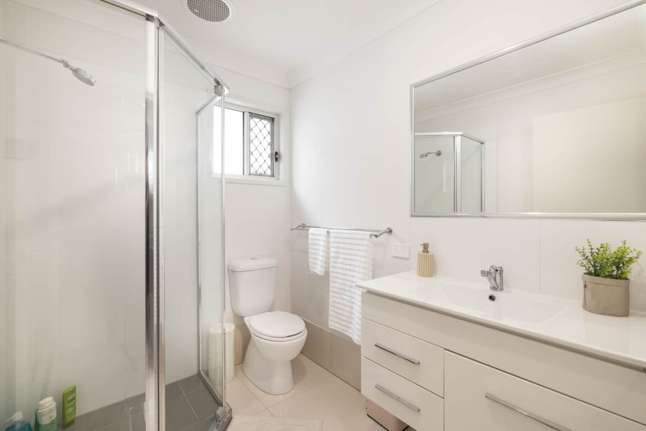 Bathroom: Stylish bathroom with walk-in shower, vanity, and clean finishes 