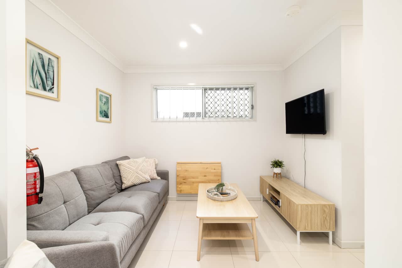 Living Area: Bright living space with comfortable seating and TV 