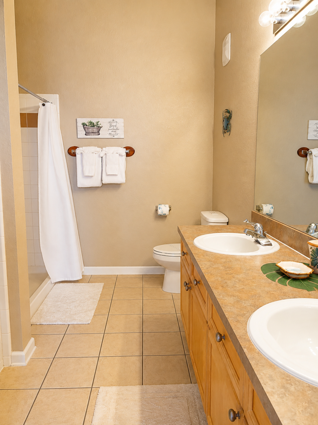 Master bath with double sinks, shower stall and soaking tub