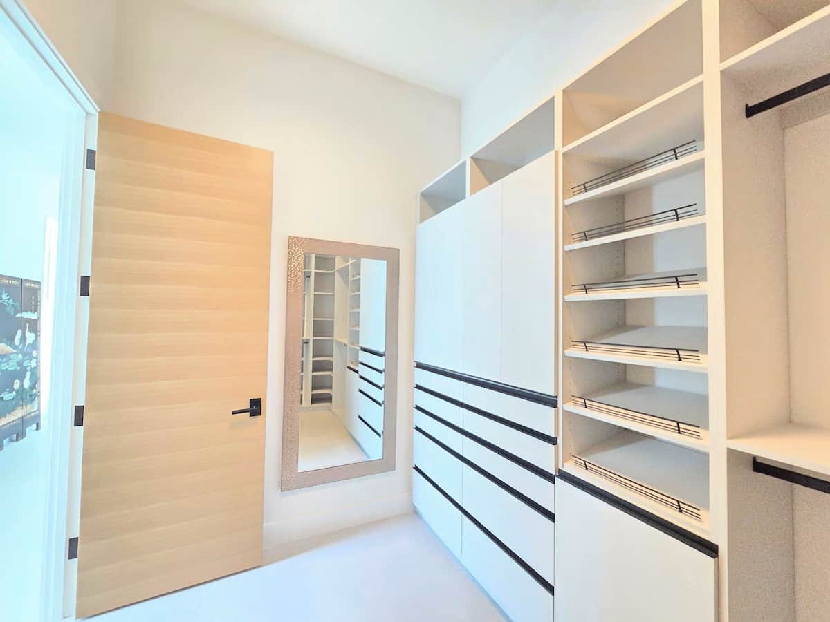 Primary Suite custom walk-in closet with built-in drawers in the primary suite at Casa Tropicana SK